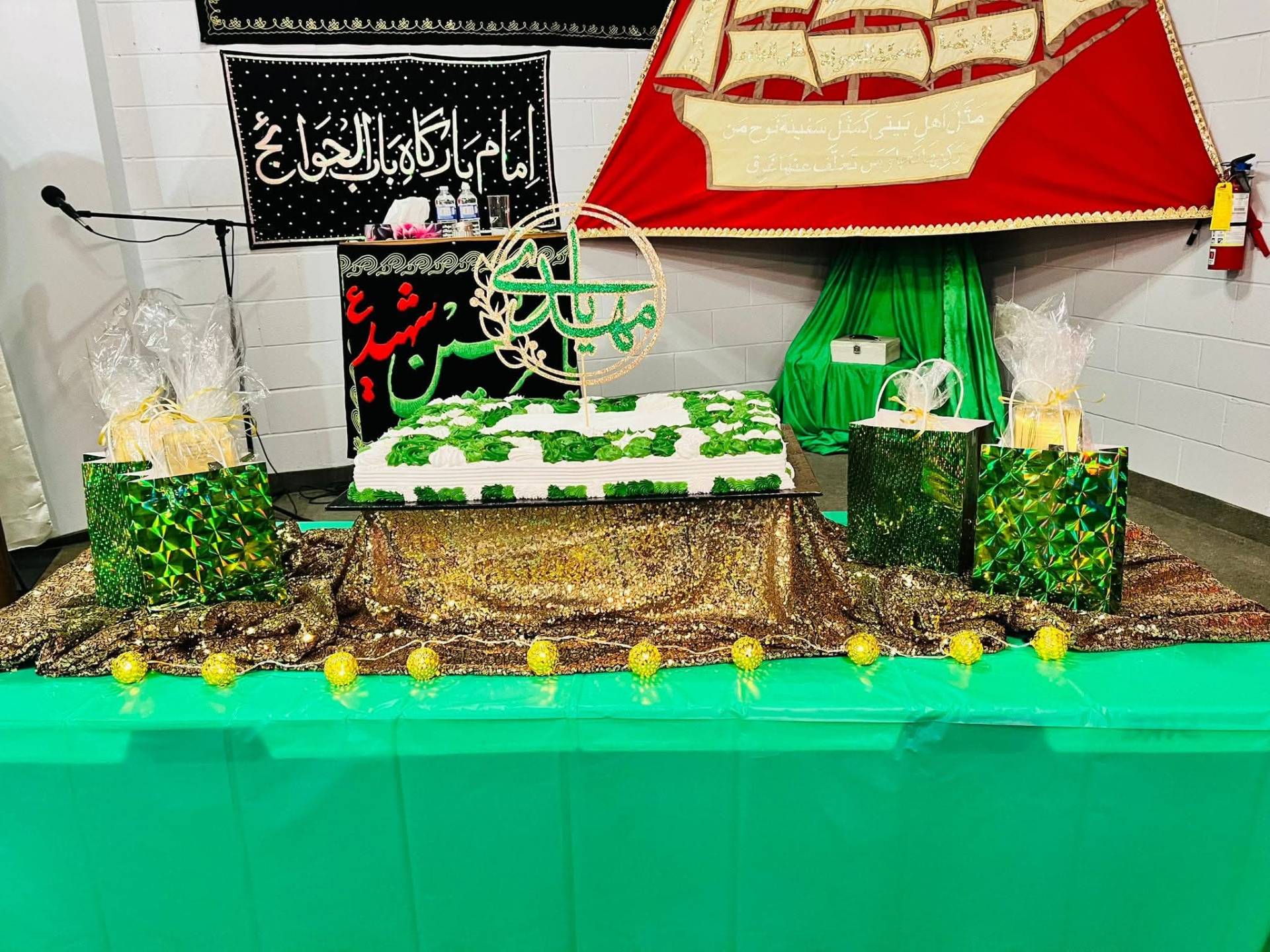 A celebration cake and gift bags set up at Bab Ul Hawaij Islamic Centre