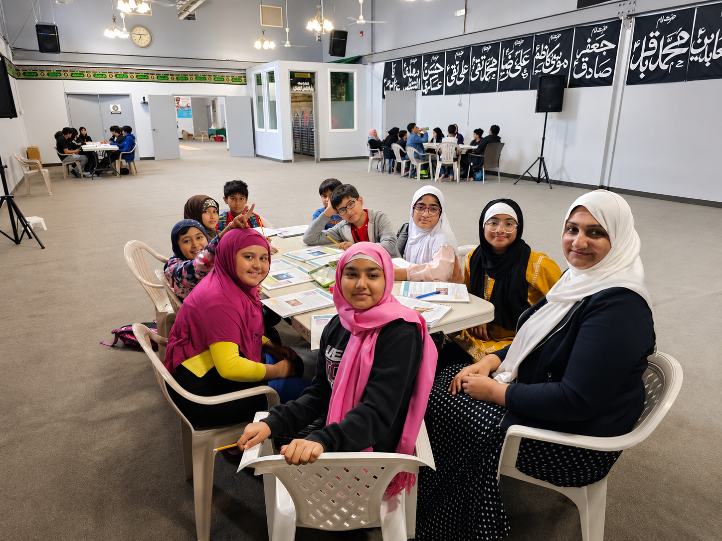 A Zainabia Academy class studying with their teacher in the main hall