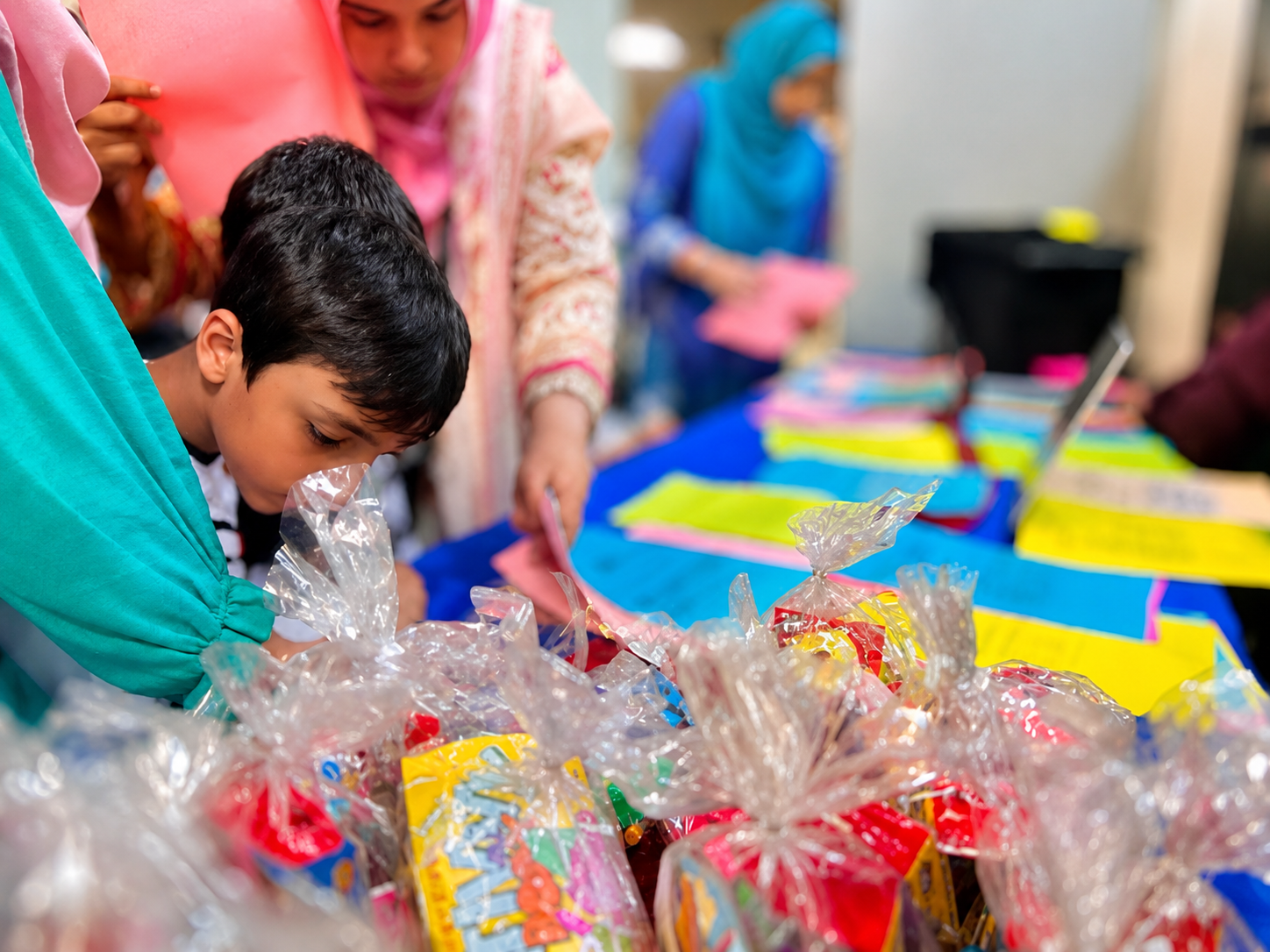 A student choosing a prize at the academy prize table
