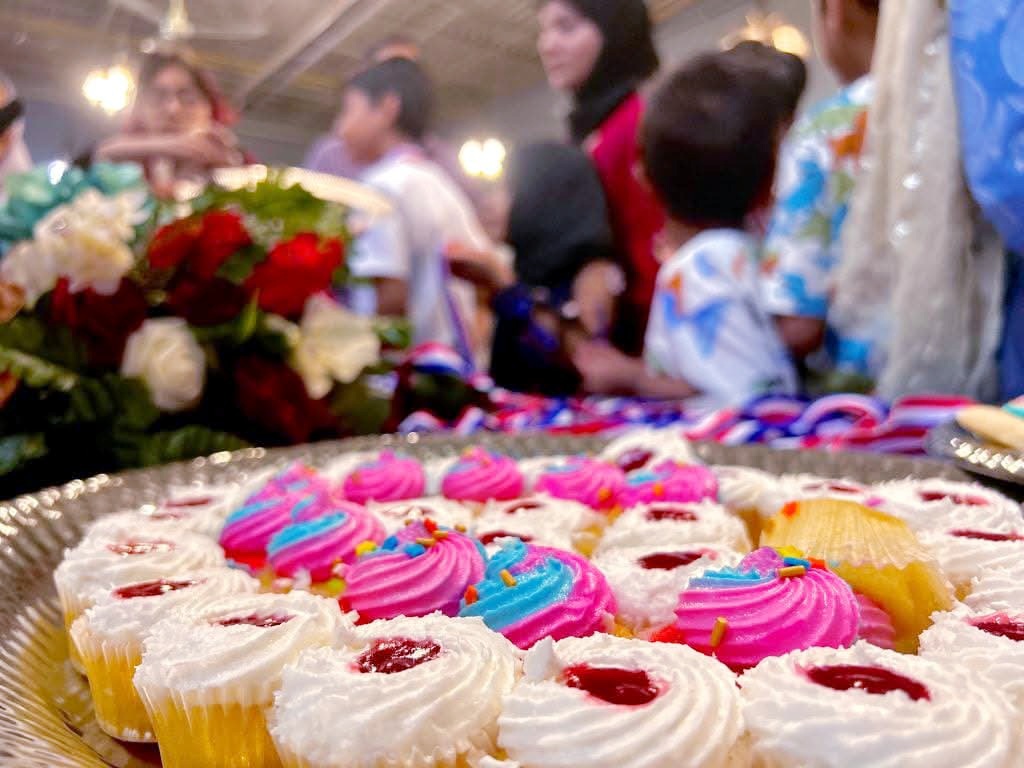 A tray of decorated cupcakes at a Zainabia Academy celebration