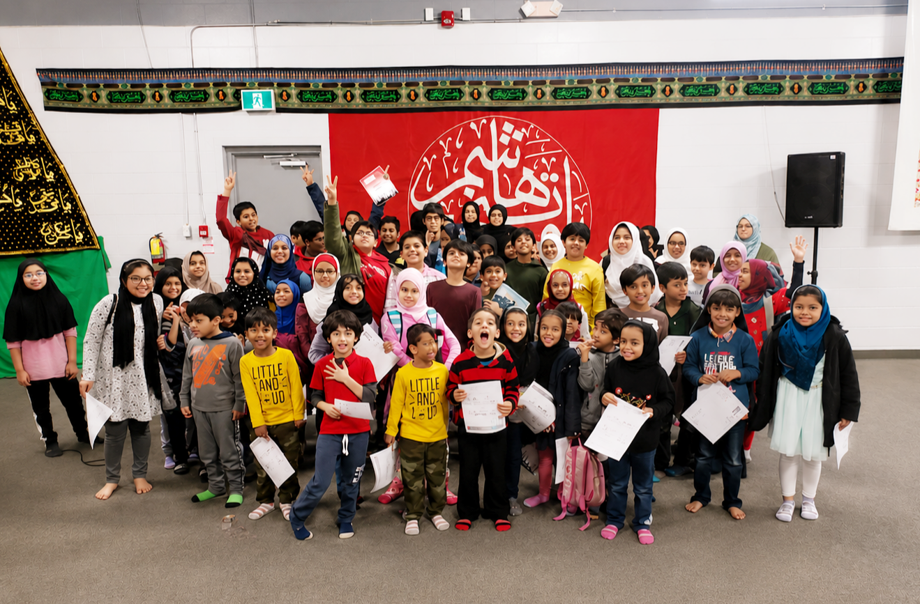 Zainabia Academy students holding their certificates at an academy gathering